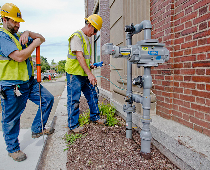 HG&E Service technicians working outside a commercial property.