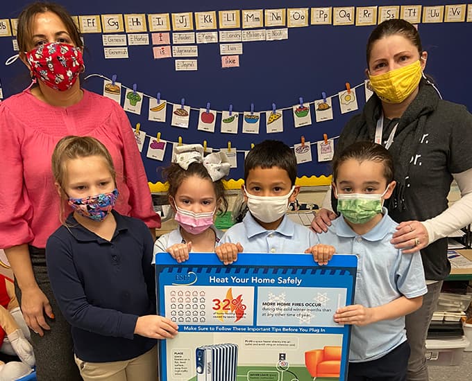 School Children and teachers with a safety poster
